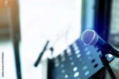 Microphone with blurry musician's lectern or music stand in music studio. photo