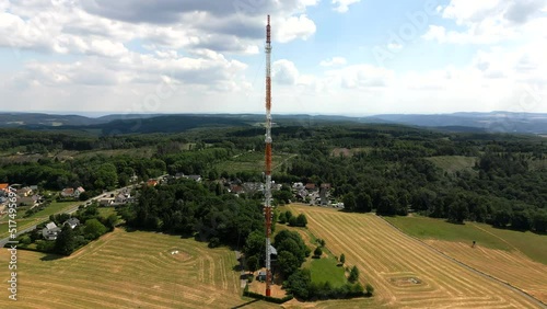 Telecommunications radio and TV mast with cell tower nearby