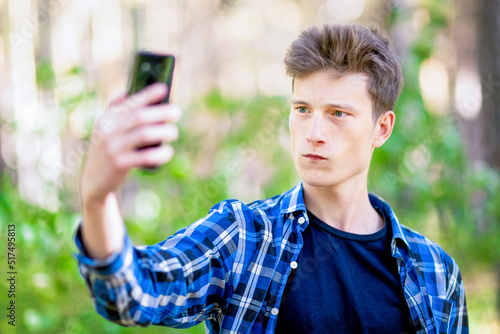 A young man is taking a pictire of himself. photo