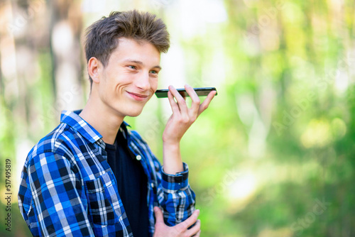 A boy has heard good news on a speakerphone.