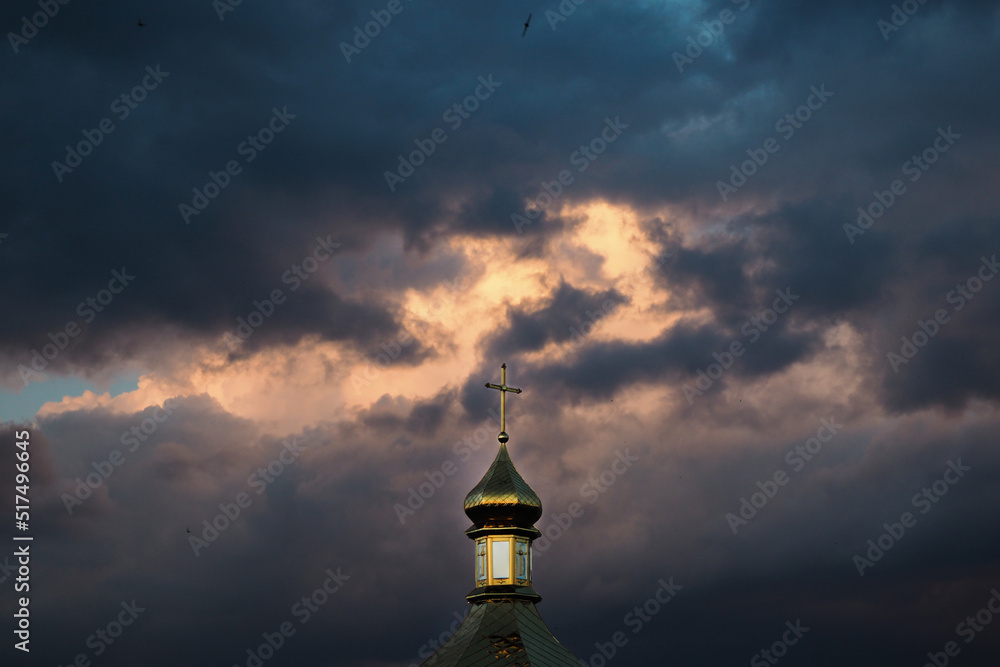 The dome of the church against the background of a gloomy sky. The concept of faith and religion. The salvation of the soul in faith in God