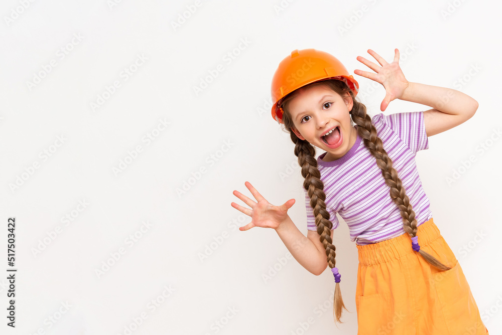 A little girl in a construction helmet spread her fingers like a fan. The concept of renovation in a children's room on a white isolated background. A little girl in a construction helmet spread her fingers like a fan. The concept of renovation in a children's room on a white isolated background.