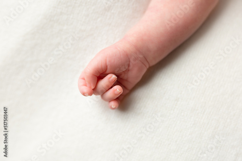 hand of a newborn baby. small pens. hands on white background