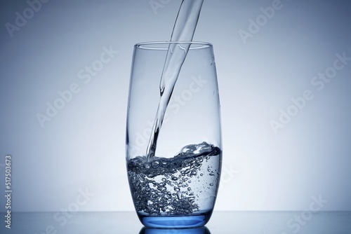 photo pouring water into a glass