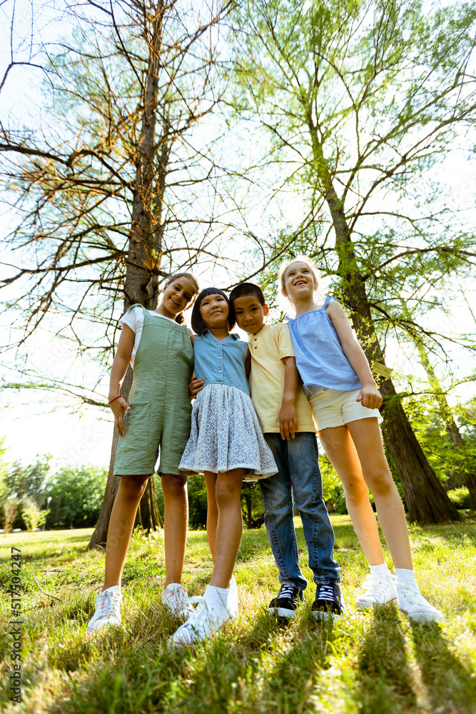 Fototapeta premium Group of asian and caucasian kids having fun in the park