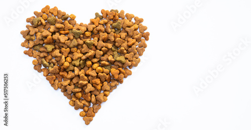 Dry food for cats or dogs in the shape of a heart on a white background. The concept of love and care for pets