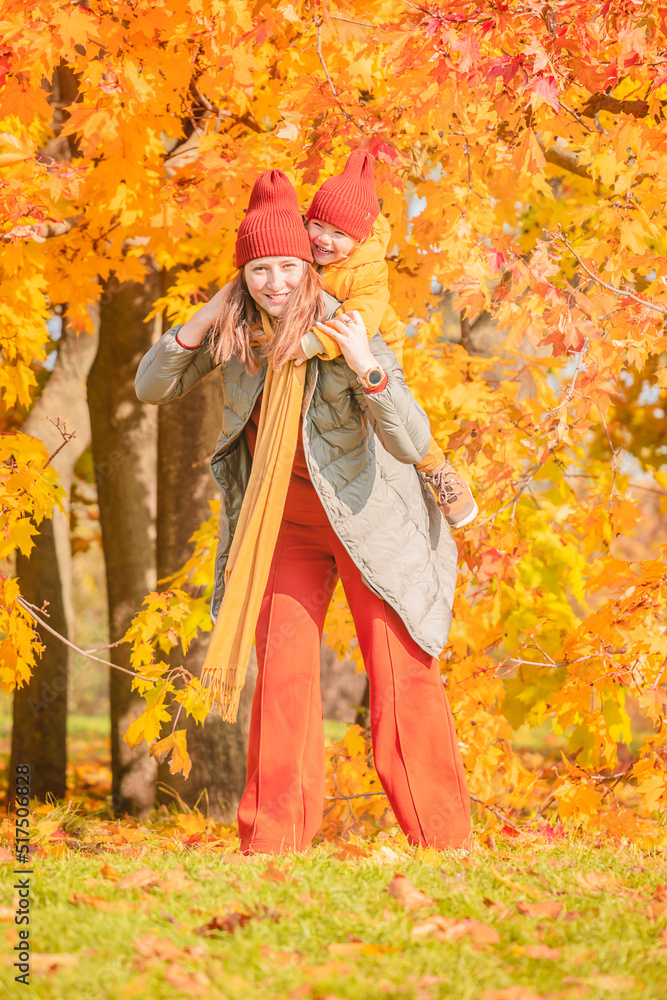 Happy mother and daughter having fun in autumn park. Happy mother and child daughter on autumn walk. Happy mother and daughter having fun in autumn park. Happy mother and child daughter on autumn walk.