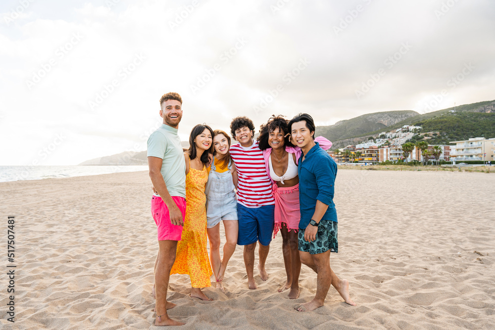 Group of young best friends bonding outdoors - Multiracial people bonding and having fun at the beach during summer vacation Group of young best friends bonding outdoors - Multiracial people bonding and having fun at the beach during summer vacation