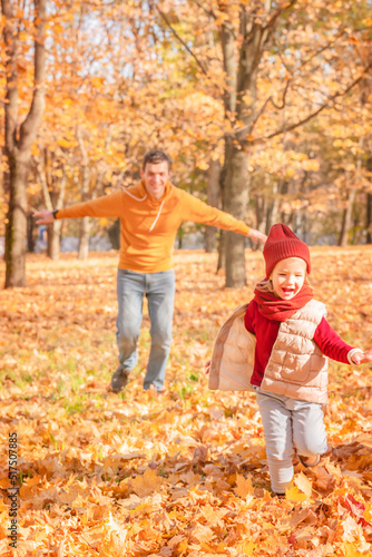Happy father and daughter enjoying autumn. Happy father and daughter having fun in autumn park 