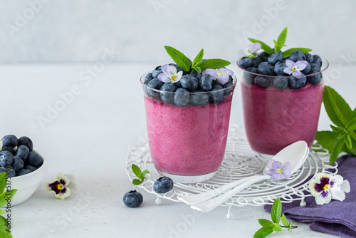 Blueberry dessert in glass, decorated with fresh berries