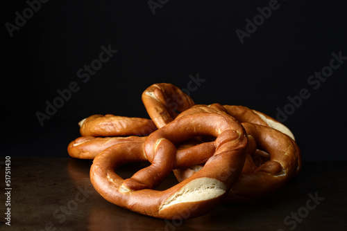 closeup soft baked pretzels on old metal tray