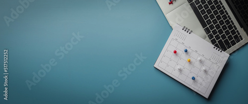Obraz na plátně Embroidered red pins on a calendar event Planner calendar,clock to set timetable organize schedule,planning for business meeting or travel planning concept