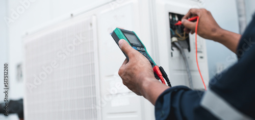 Wallpaper Mural Air conditioner technicians use a multimeter to check electricity and Part of the preparation to install a new air conditioner. Torontodigital.ca