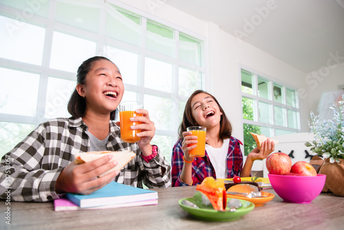 Teenage girls enjoy eating breakfast before go to school, Back to school concept
