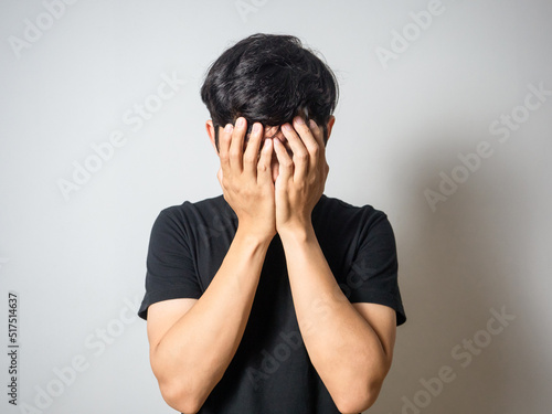 Depressed man hold his face  feels hopeless white background