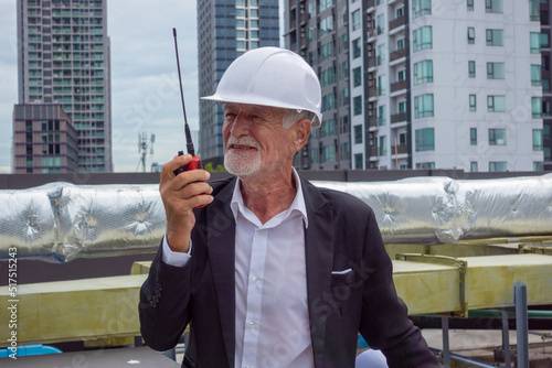 Two experts inspect real estate construction site with civil engineer engineer under checking the industry chilled water fan coil unit air conditioner is water cooling tower air chiller HVAC system of