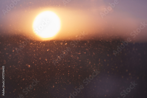 Closeup photo of dirty window with beautiful sunset on background