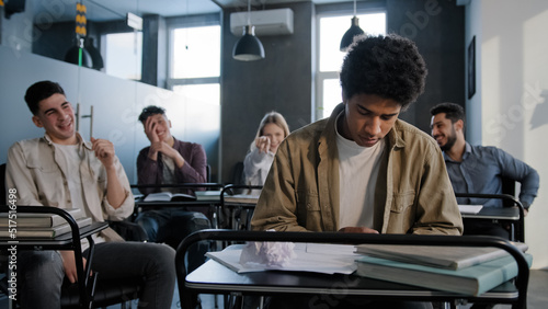 Foto Unhappy african american student loser feeling mocking bullying anger from class