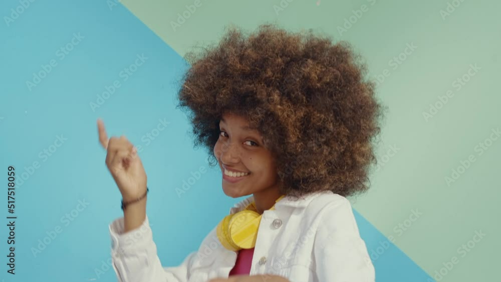 Beautiful young woman with curly hair having fun and doing activities outdoor in Paris. Concept about people and lifestyle Beautiful young woman with curly hair having fun and doing activities outdoor in Paris. Concept about people and lifestyle