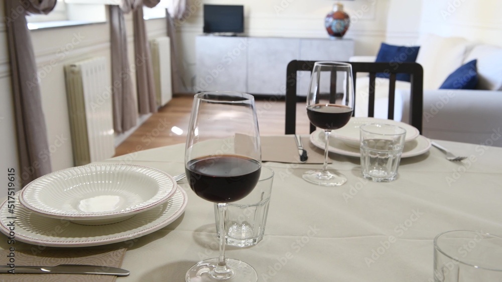 Table set with wine glasses, plates and crockery Table set with wine glasses, plates and crockery