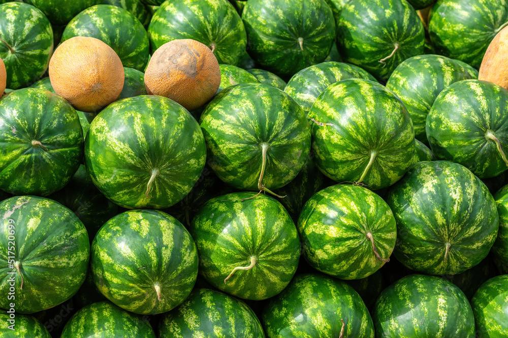 Many big sweet green watermelons and some melons market Many big sweet green watermelons and some melons market
