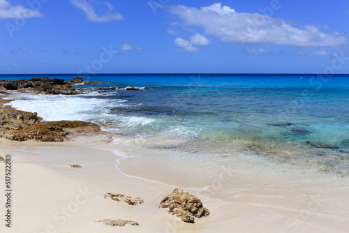 Oceanfront, golden sands and waves on the island of St. Maarten photo