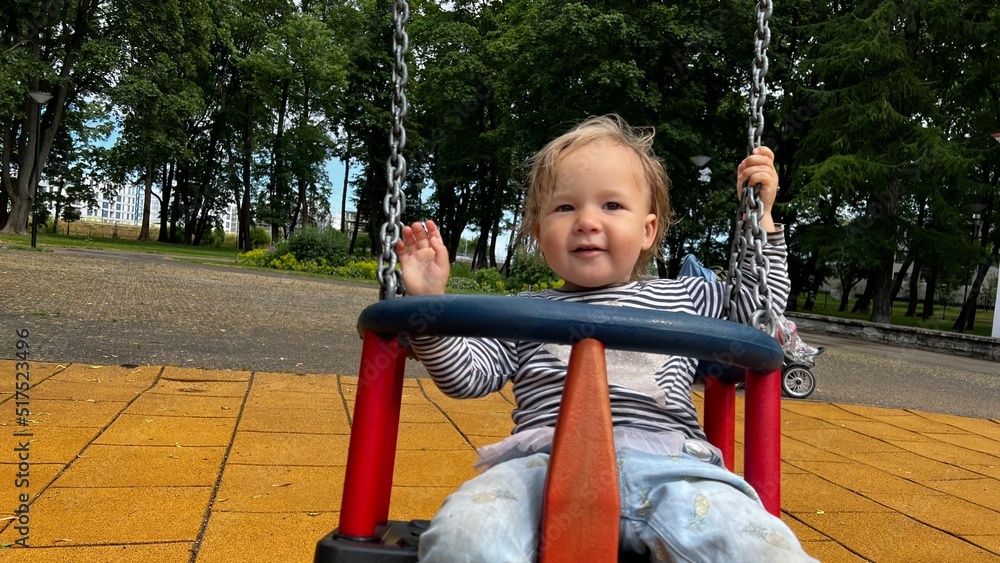 custom made wallpaper toronto digitalHappy toddler sitting in a swing at the playground