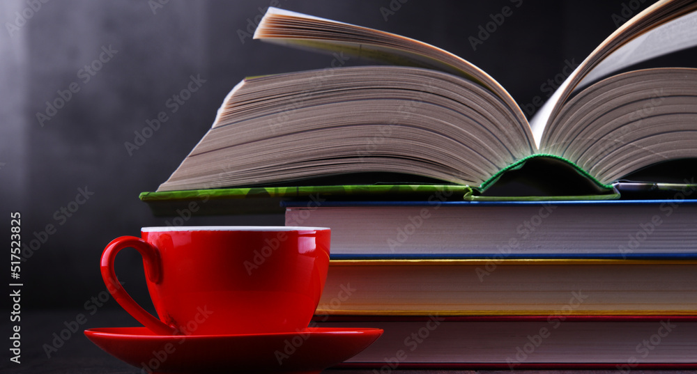 Naklejka premium Composition with books and cup of coffee on the table