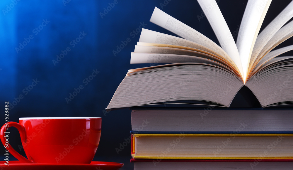 Naklejka premium Composition with books and cup of coffee on the table