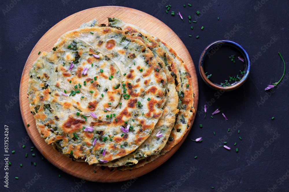 Homemade appetizing scallion pancakes served with soy sauce.