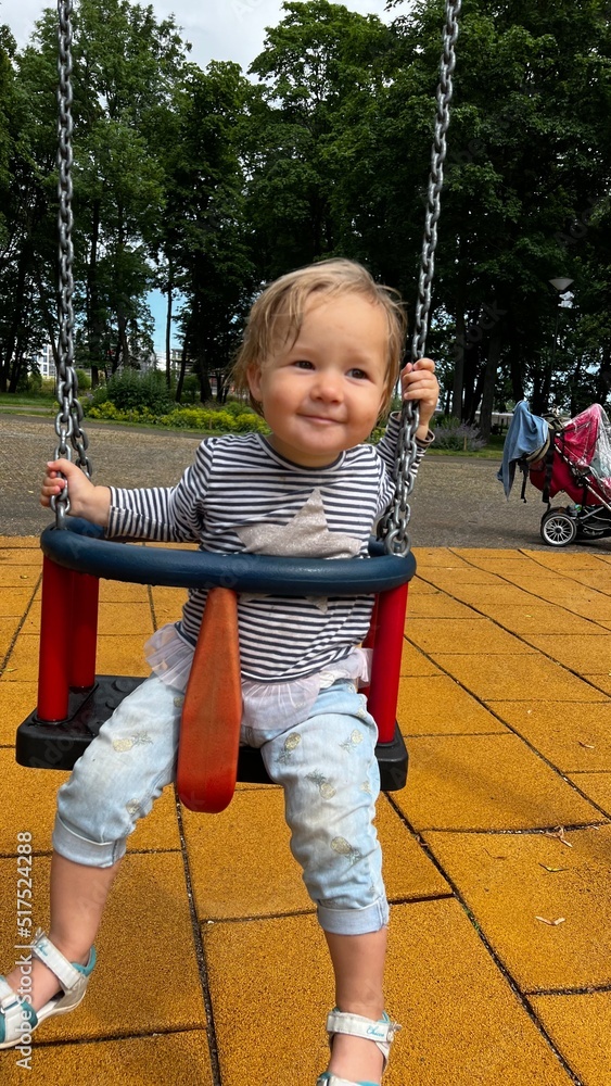 custom made wallpaper toronto digitalHappy toddler sitting in a swing at the playground