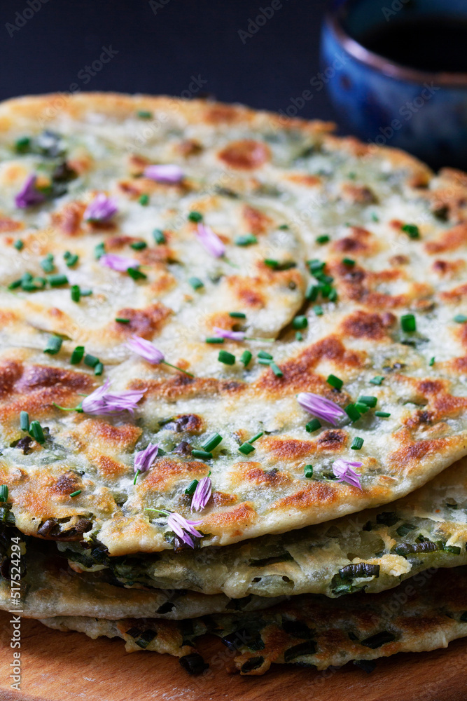 Homemade appetizing scallion pancakes served with soy sauce.