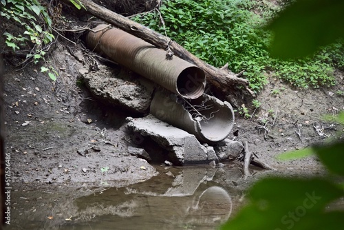 water drainage pipe flowing into the water