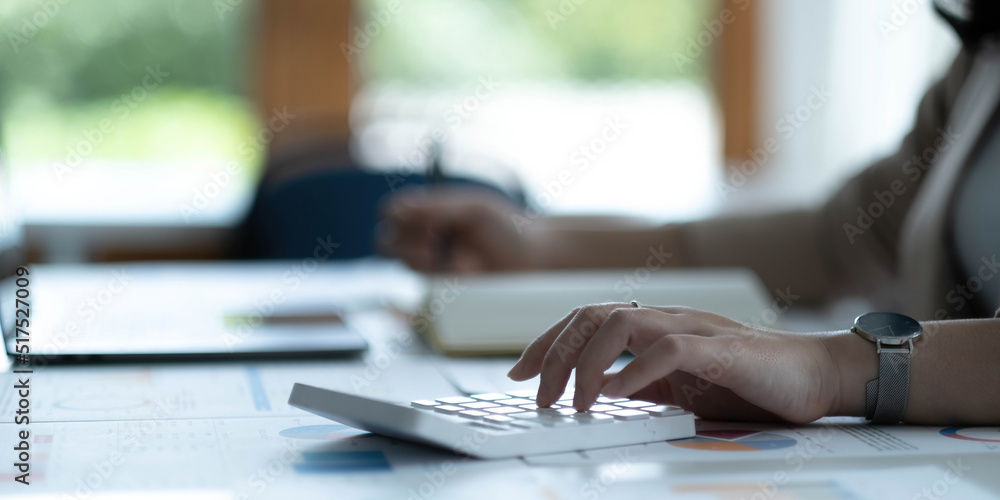 Close up Business woman hand using calculator to calculate the company's financial results and budget. Account Audit Concept. Close up Business woman hand using calculator to calculate the company's financial results and budget. Account Audit Concept.