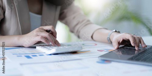 employee accountant woman hand press on calculator for make financial report or company's profit monthly at desk , bookkeeper job and work from home concept