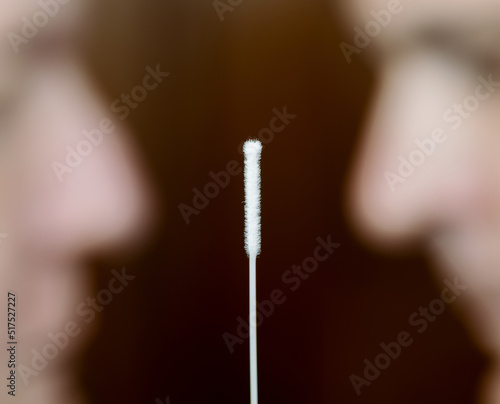 Covidtest sticks with male face in the background. © martinpixel