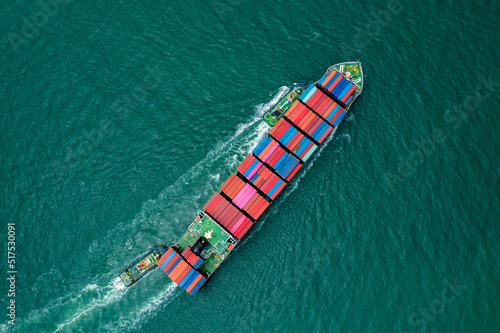 aerial top view of container ship carrying cargo container import export internatioonal and worldwide, business and industry goods logistic transportation by container ship in open sea,