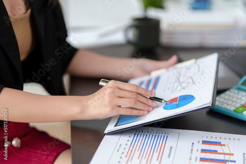 Close-up of businesswoman hands to check company finances and earnings and budget. Business woman calculating monthly expenses, managing budget, papers, loan documents, invoices.
