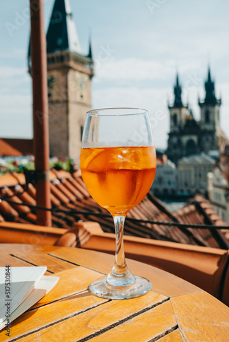 Photography Aperol Spritzes cocktail on background of old Prague town square with Church, astronomical clock