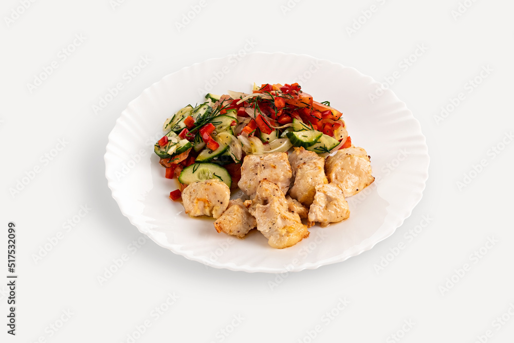 Pieces of fried chicken kebab with vegetables are on a white plate. Isolate on a white background, horizontal orientation, copy space, no people Pieces of fried chicken kebab with vegetables are on a white plate. Isolate on a white background, horizontal orientation, copy space, no people