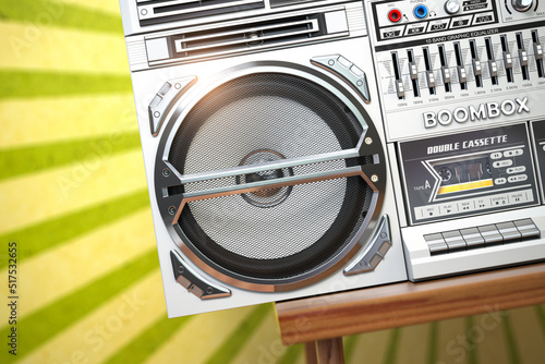 Retro ghetto blaster boombox, radio and audio tape recorder on vintage background.