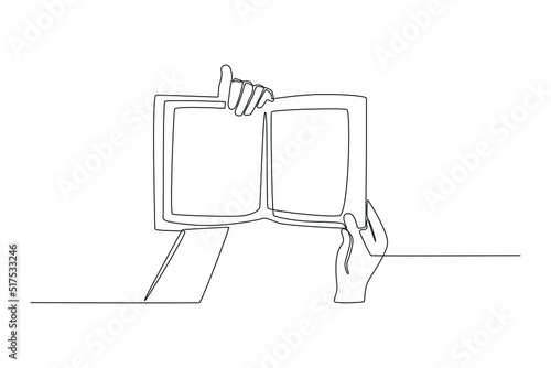 Single one line drawing hands holding open book. Books lovers day concept. Single line draw design vector graphic illustration.