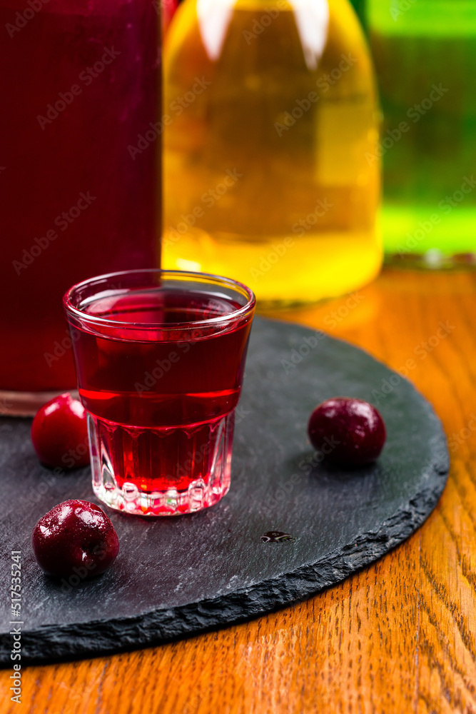 Homemade infused vodka, tincture or liqueur of red cherry. Berry alcoholic drinks concept. Homemade infused vodka, tincture or liqueur of red cherry. Berry alcoholic drinks concept.
