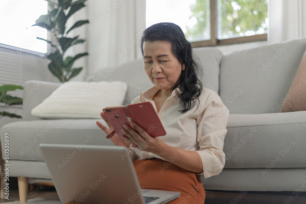 Happy Asian senior elderly old woman using mobile phone receiving new message on smart phone Happy Asian senior elderly old woman using mobile phone receiving new message on smart phone