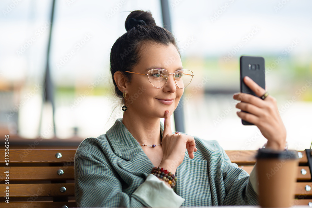 Close-up of a 35 years old woman with smartphone during an online video call.