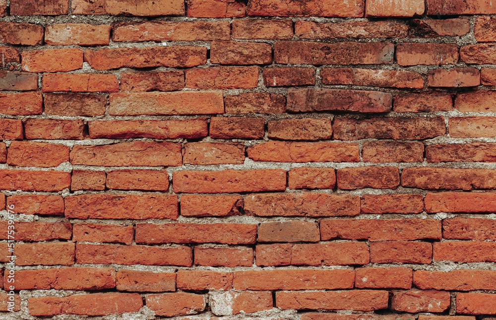 Obraz premium Red brick wall texture. Abstract brick wall background, wall of old, cracked bricks, with a weathered and faded surface. 