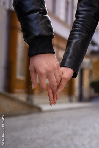 Lovely couple holding hands together outdoors, closeup. Romantic date