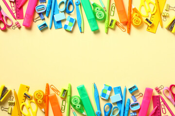 Frame of colorful school supplies on yellow background. Flat lay, top view, copy space. Back to school concept