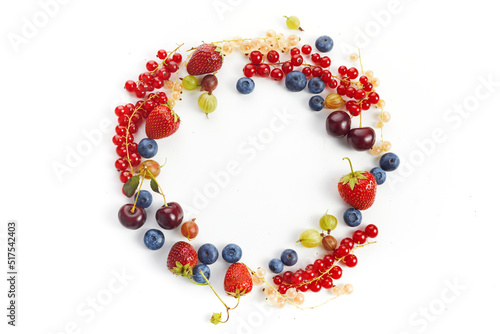 Various fresh summer berries round frame on white background. Top view