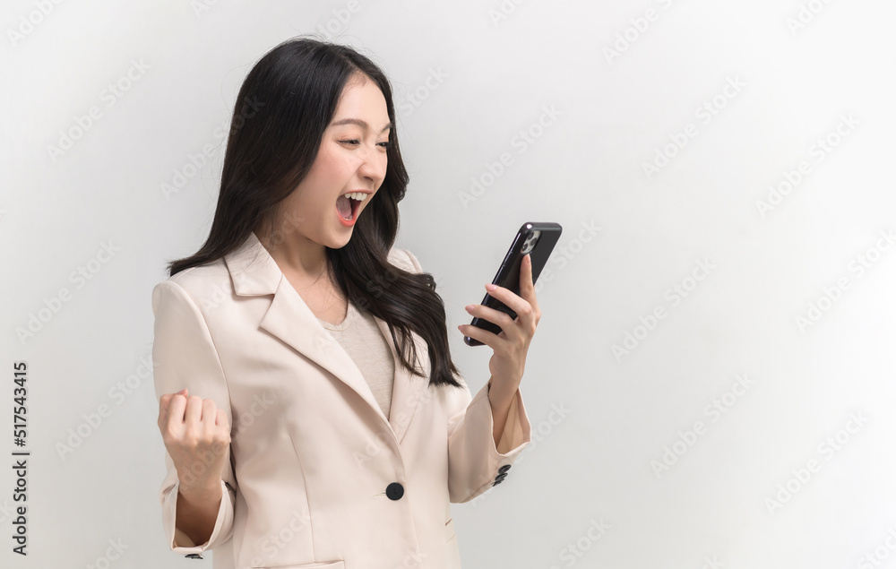 Portrait photo of young beautiful Asian woman feeling happy or surprise shock and holding smart phone with black empty screen on white background can use for advertising or product presenting concept. Portrait photo of young beautiful Asian woman feeling happy or surprise shock and holding smart phone with black empty screen on white background can use for advertising or product presenting concept.